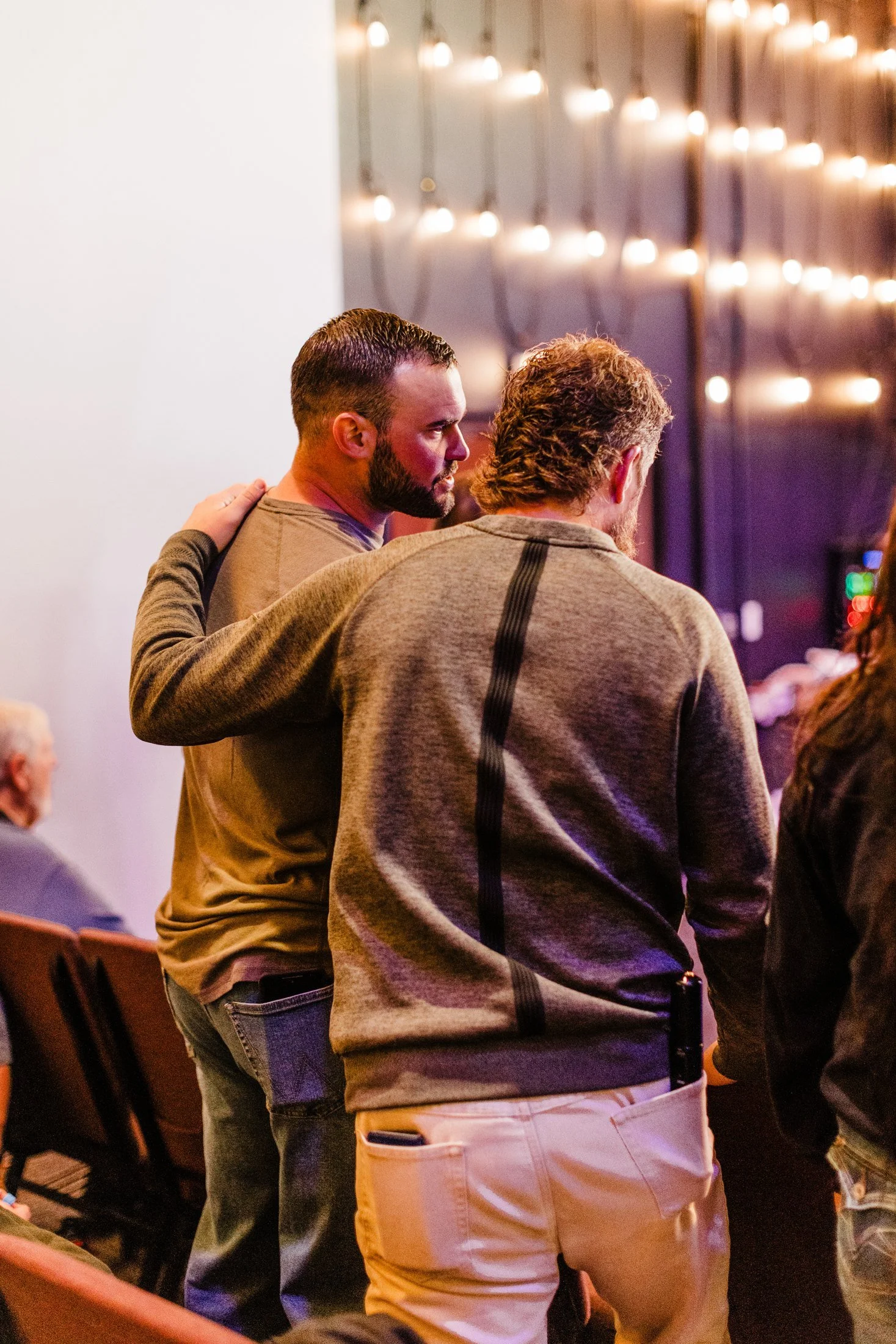 Two members of Solid Rock Church praying together. Photo by Sarah LaDuke.